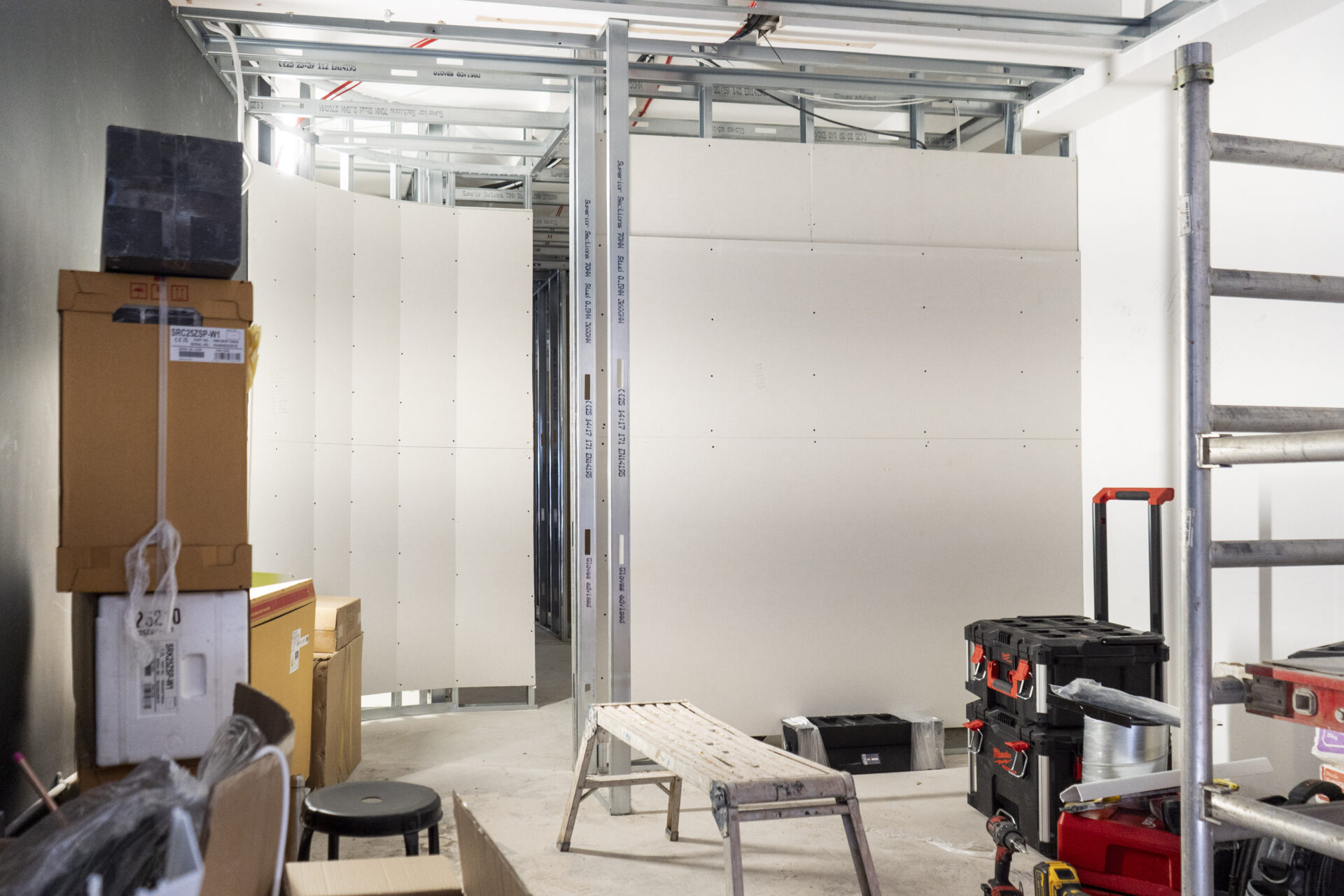 ON-SITE PROGRESS | Framing and wall installation in progress, laying the foundation for the studio’s choreographed sequence of spaces.