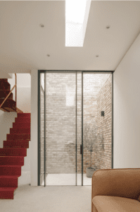 Sunken courtyard at basement level, internal spaces held beneath a 3.1m ceiling.